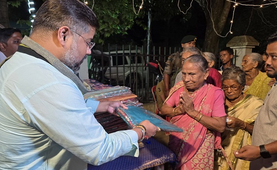 Tourism Minister Sushanta Chowdhury distributes clothes among residents of Radhanagar Awasan, Agartala on Ganesh Puja.